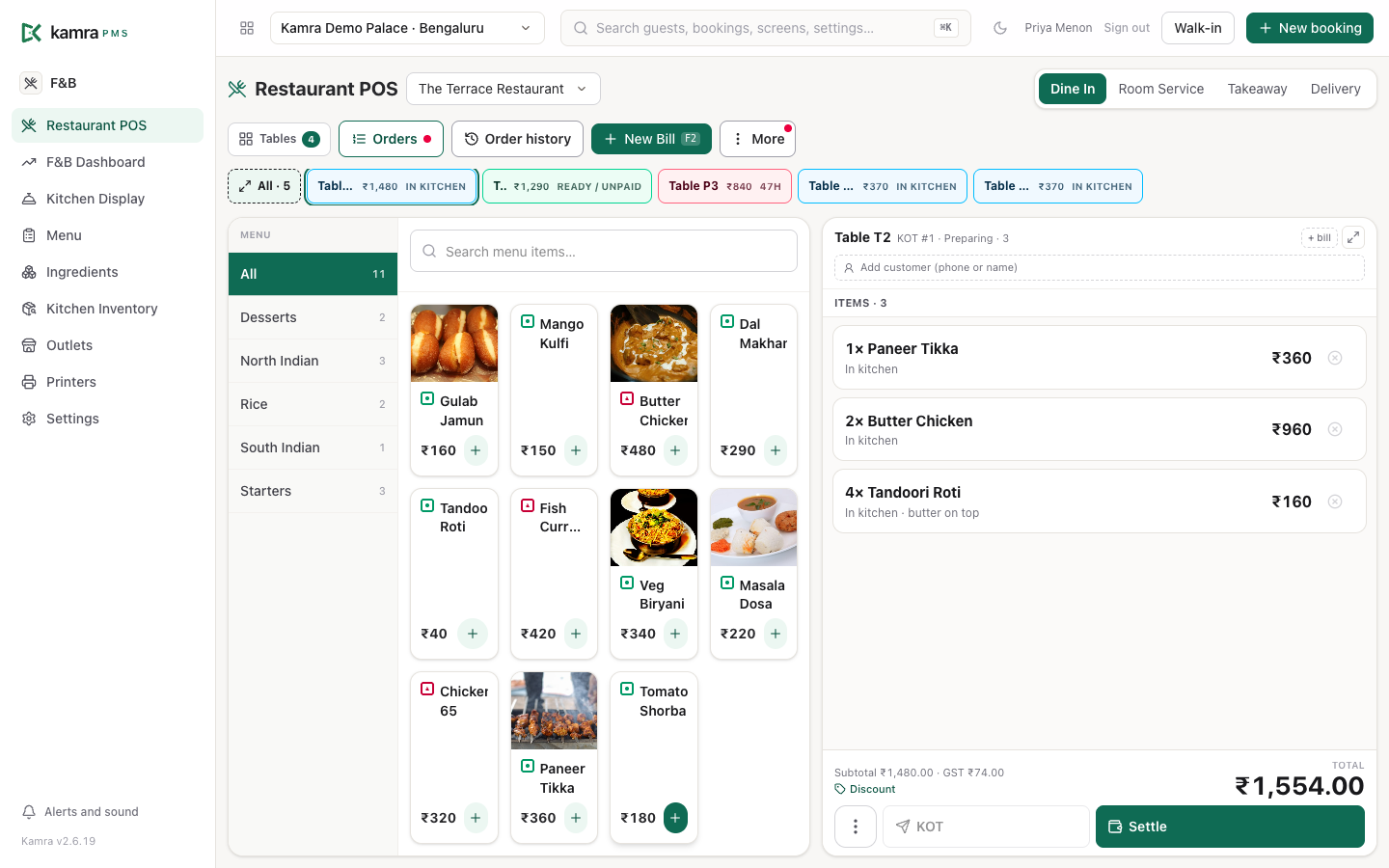 The restaurant POS: open bills along the top, the menu by category in the middle and the running bill for Table T2 on the right