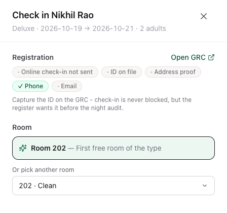 The check-in panel for Nikhil Rao: registration chips, the suggested room 202 and a list of other free rooms